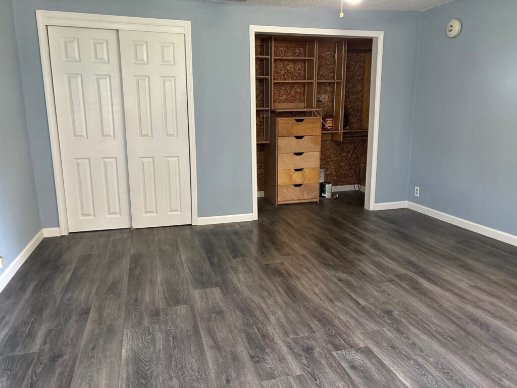 Restored bedroom with new flooring and clean walls after mold remediation by MRC Restoration in Farmington MO