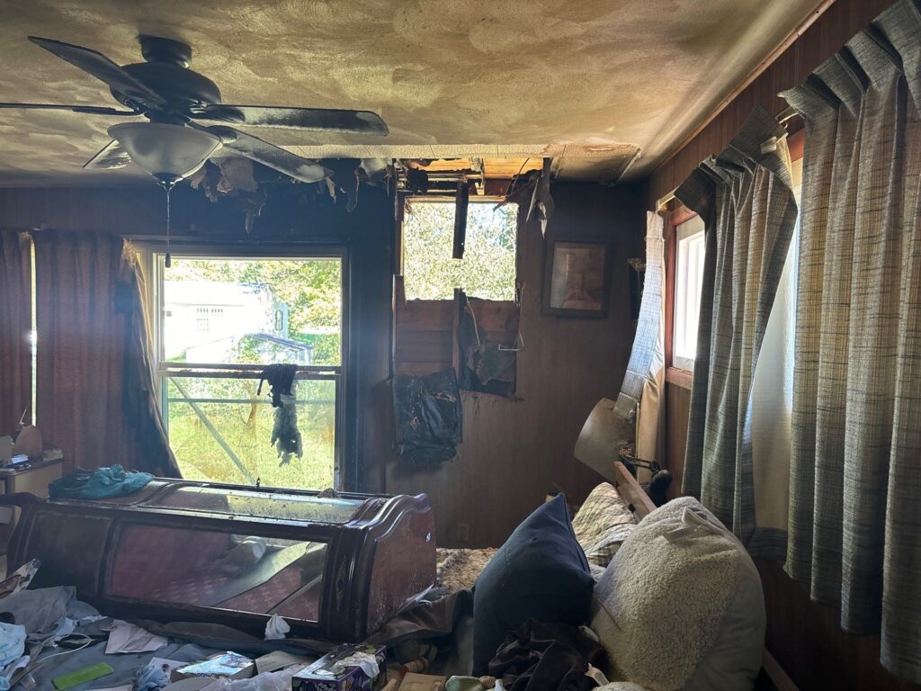 Before photo of a fire-damaged home in Cape Girardeau, Missouri, showing extensive soot and structural damage.