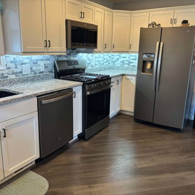 Specialty Services by MRC Restoration for kitchen reconstruction after fire damage, featuring modern appliances and updated finishes.