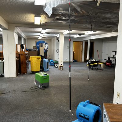 Drying equipment setup in a commercial office for water damage restoration.