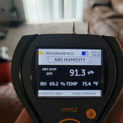 High humidity levels displayed on a digital moisture detector, indicating the need for mold remediation services to prevent mold development.