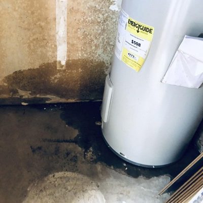 Water heater leak damage requiring cleanup and repair services.